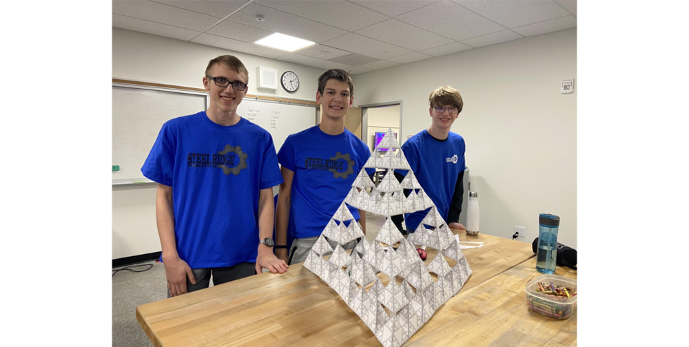 Members of the Steel Ridge Robotics team show off a successful paper structure build