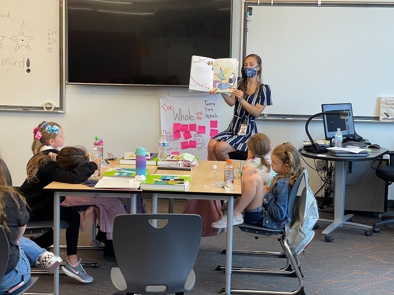 Teacher Braelyn Johnson reads to her students during snack time