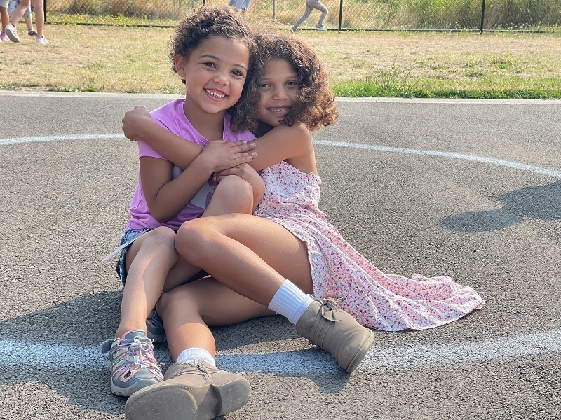 Sisters Hensley (left) and Corayln Hulegaard enjoying some time together at recess