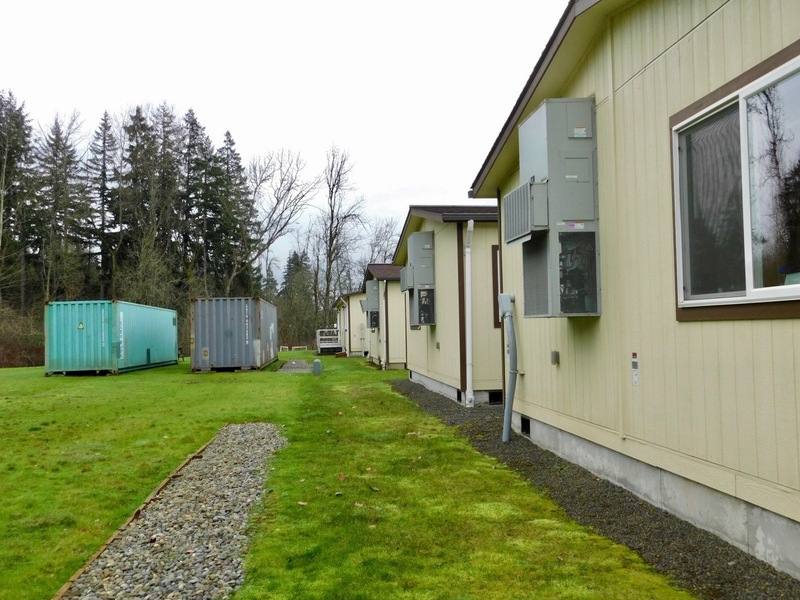 Behind a fleet of portable classrooms, two storage containers provide additional storage for the school, since many former storage spaces have been pressed into other use