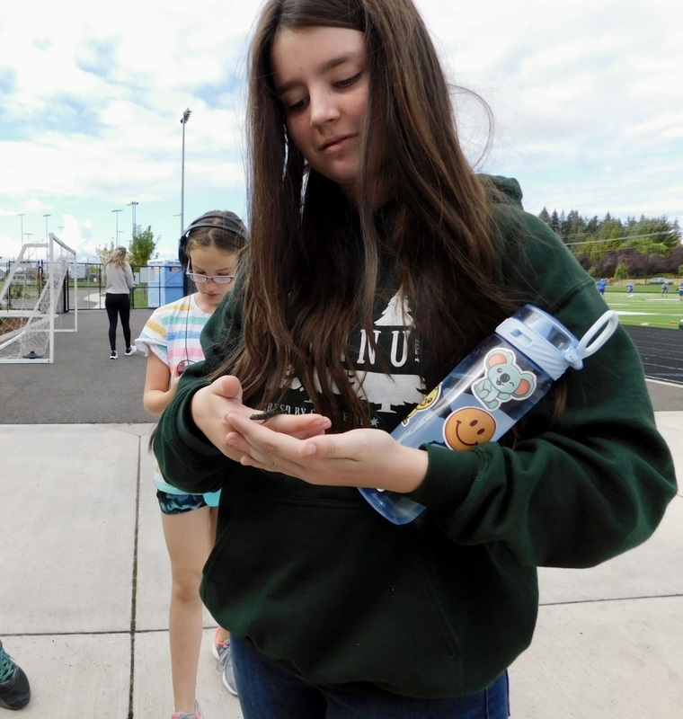 Olivia Bergeron rescued a tiny salamander from the track before her run