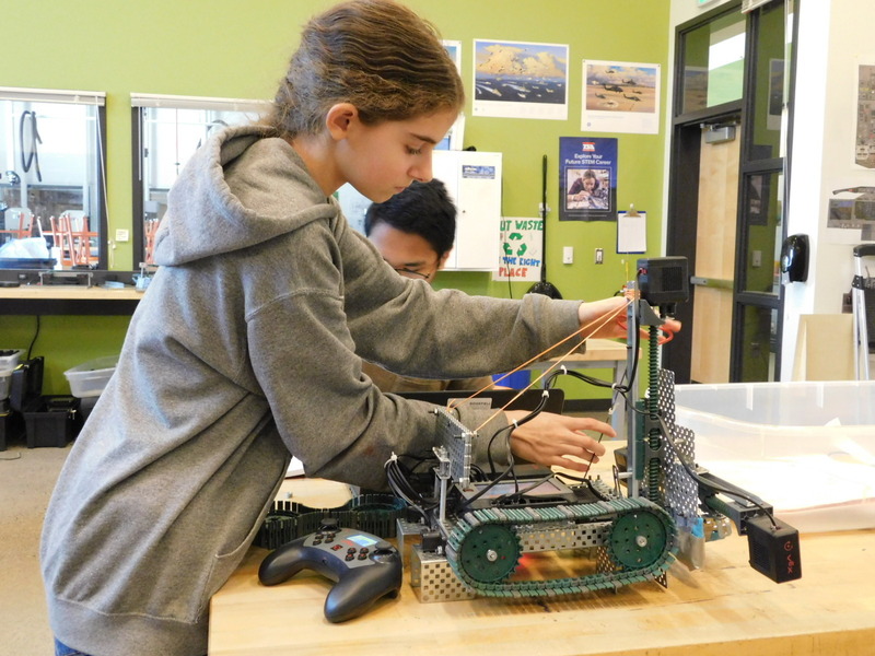 View Ridge Middle School students (L to R) Lacey Bennett and Micah Nguyen prepare to switch the motor on their robot